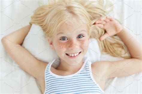 Cute Little Female Child With Blonde Hair Blue Eyes And Freckled Face