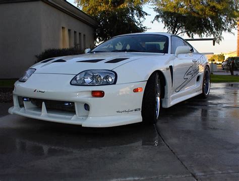 Animated character printed white coupe wallpaper, super car. Free Cars Wallaper: Toyota Supra Modified
