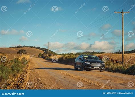Car On Dirt Road Passing Through Rural Lowlands Editorial Photography