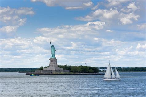 View Of The Statue Of Liberty In New York City With Boats In The