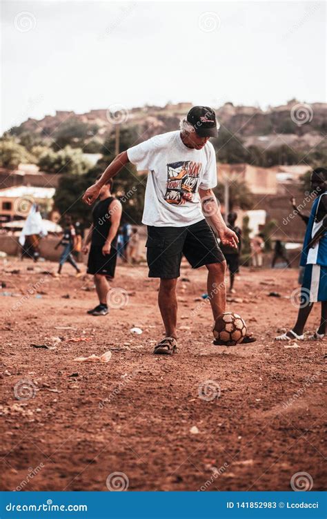 Black African Children Playing Soccer With Caucasian Volunteer