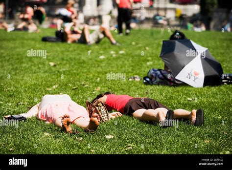 Two People Lying Down In The Park Stock Photo Alamy