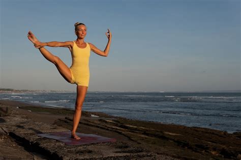 Free Photo Beautiful Woman Doing Yoga On The Beach