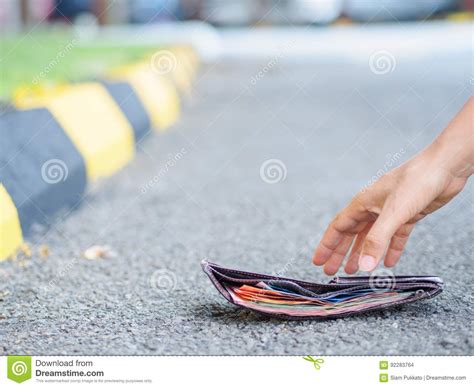Close Up Of A Woman Picking Up Fallen Wallet Stock Photo Image Of