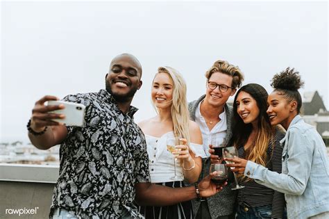 Diverse Group Of Friends Taking A Selfie At A Rooftop Party Premium