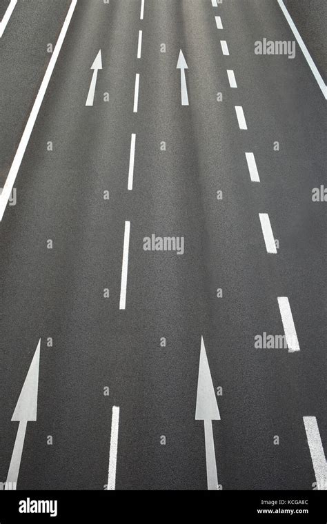 Roadway With Road Surface Marking And Arrows Pointing Straight Stock