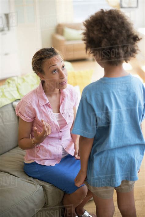 Mother Talking To Son In Living Room Stock Photo Dissolve