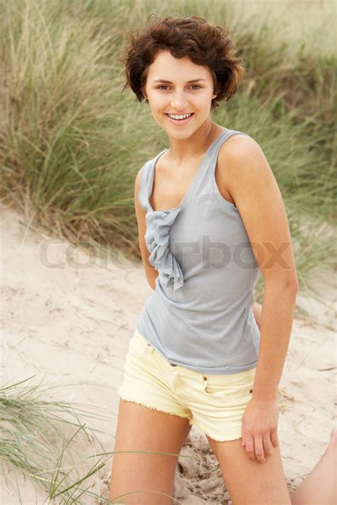 Attractive Young Woman Kneeling Amongst Sand Dunes Stock Image Colourbox