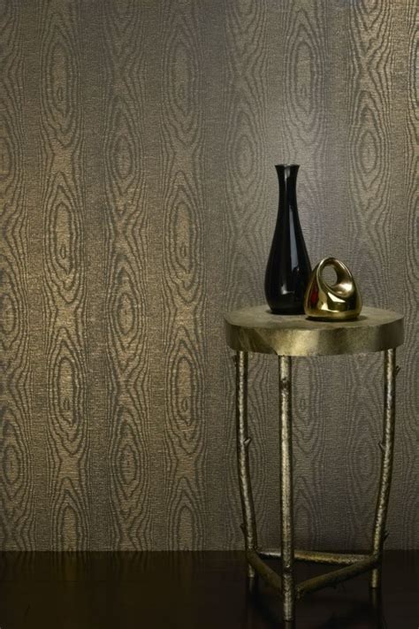 Two Vases Are Sitting On A Table In Front Of A Wallpapered Background