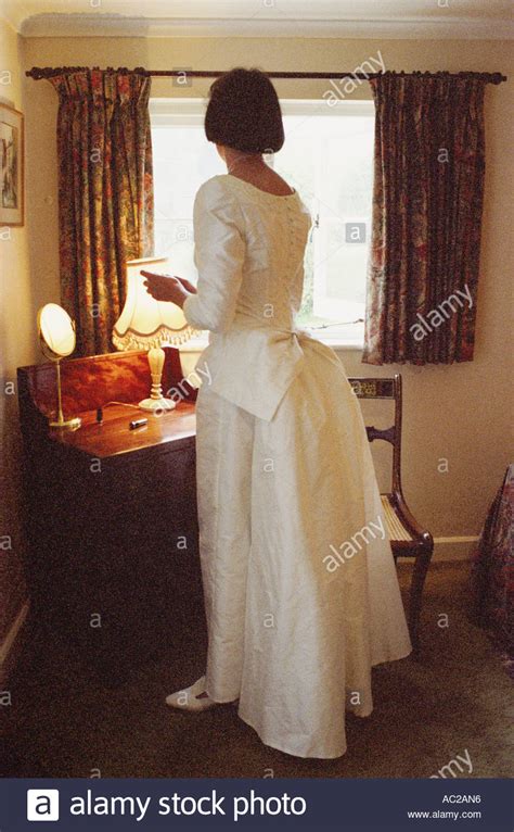 Bride Putting On Make Up Before Her Wedding In Her Bedroom In The 1990