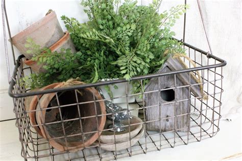 Using Faux Floral And Greens In The Farmhouse Wire Basket Decor
