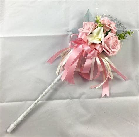 this pretty rose wand features three artificial roses underneath the roses is a coordinating