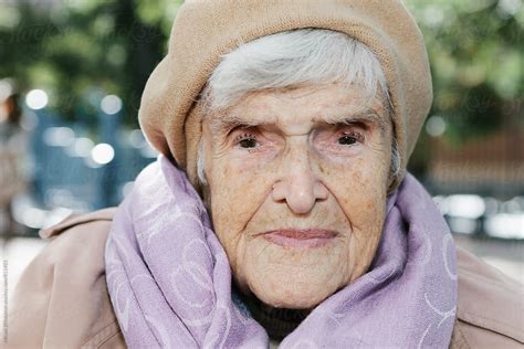 Portrait Of A Stern Elderly Woman In Her 90s Sitting Outside In The