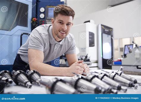 Portrait Of Male Engineer With Cad Drawings In Factory Stock Photo