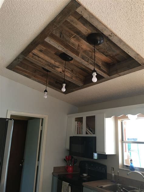 A ceiling can be the mood maker of the room. We had fluorescent lighting used pallet wood to line the ...