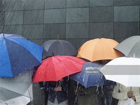 Group Of People Under Umbrellas In Rain High Res Stock Photo Getty Images