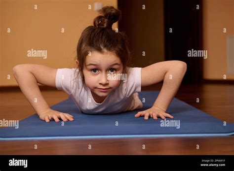 Close Up Front View Of Adorable Active Little Girl Doing Push Ups On A