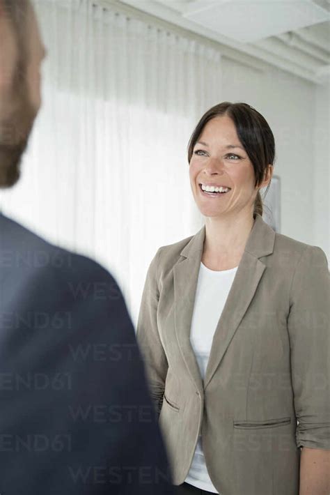 Coworkers Talking In Office Stock Photo