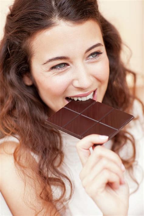Woman Eating Chocolate Photograph By Ian Hooton Science Photo Library