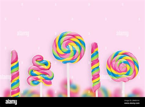 Five Colored Lollipops Of Different Shapes On A Pink Background Stock