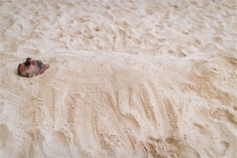 Best Man Buried In Sand Stock Photos Pictures And Royalty Free Images