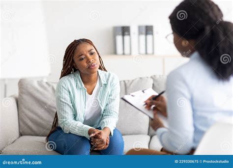 Anxious Black Woman Having Counseling Session With Therapist At Clinic