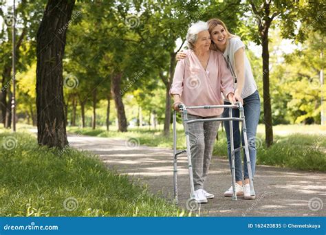 Caretaker Helping Elderly Woman With Walking Frame Stock Image Image