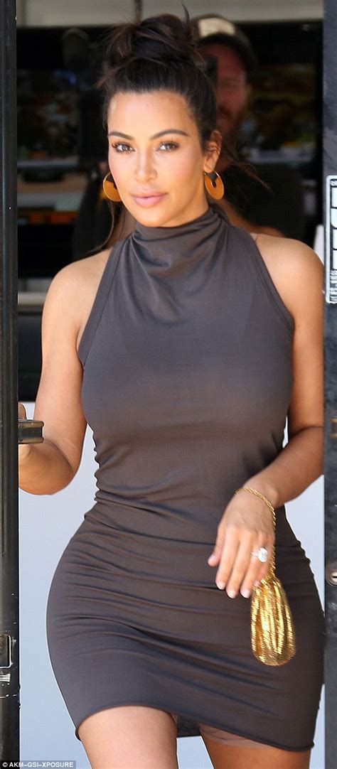 Kim Kardashian Squeezes Shapely Rear Into A Tailored Turtleneck Dress