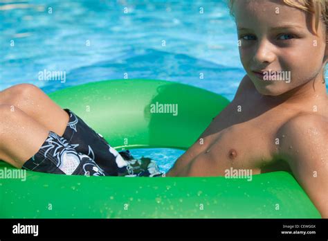 Boy Relaxing On Float In Pool Portrait Stock Photo Alamy