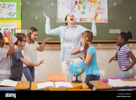 Pupils Running Wild In Classroom Stock Photo Alamy
