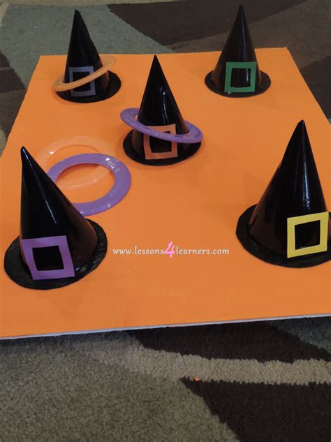 Several Black Witches Hats Sitting On Top Of An Orange Table With