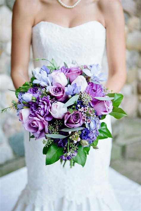 beautiful bridal bouquet comprised of purple dahlias purple chrysanthemums purple roses ligh