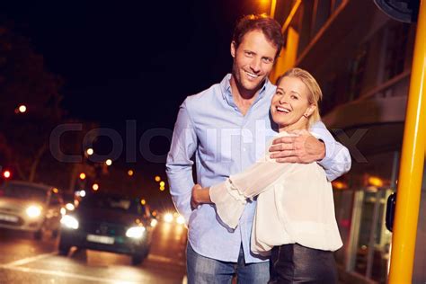 Couple Embracing On City Street At Night Portrait Stock Image Colourbox