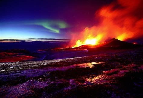 The Northern Lights Dance Behind Icelandic Volcano