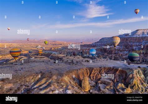 Hot Air Balloons Flying Over Ürgüp And Fairy Chimney Landscapes In