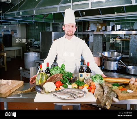 Professional Chef In Hotel Kitchen With Display Of Fresh Local Produce