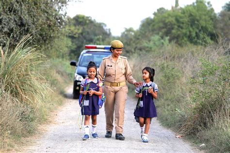 Woman Police Officer Walking Two Little Girls · Free Stock Photo