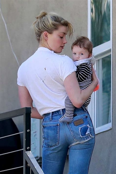 On thursday (1 july), the. amber heard cradled her friend's baby while visiting her ...