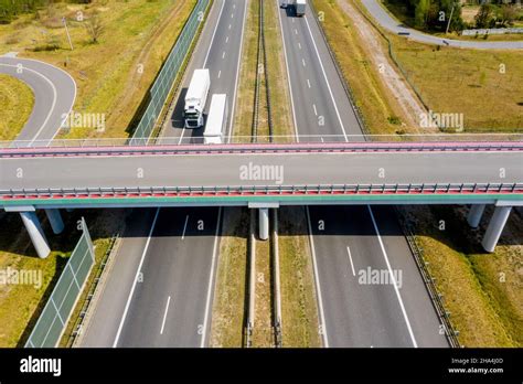 Cars and freight semi truck driving on busy highway across the country