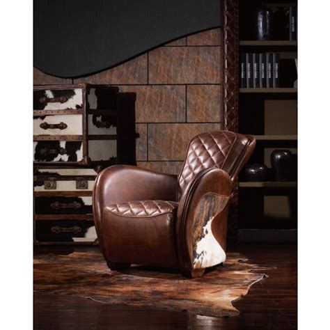 Check out the cowhide/western chair with it's carved frame and cowhide back. Saddle Brown Leather Cowhide Occasional Chair with Stool