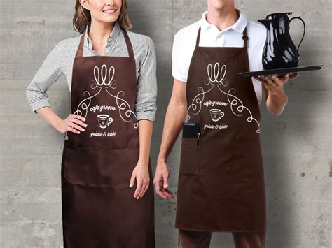 Two People Standing Next To Each Other Wearing Brown Aprons And Holding