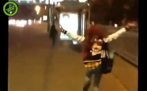 drunk russian girl crashes through glass bus stop [video]