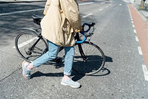 Man Crossing The Street With Bike By Stocksy Contributor Mattia