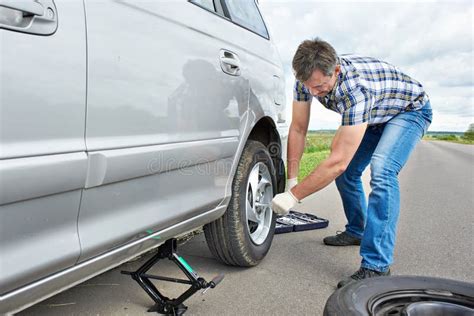 Man Changing A Spare Tire Of Car Stock Image Image Of Road Service