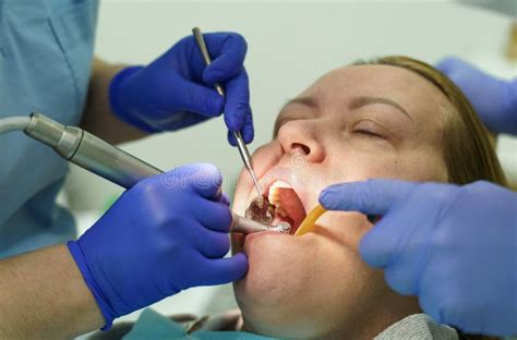The Dentist Treats The Teeth Of The Patient In The Clinic Stock Image