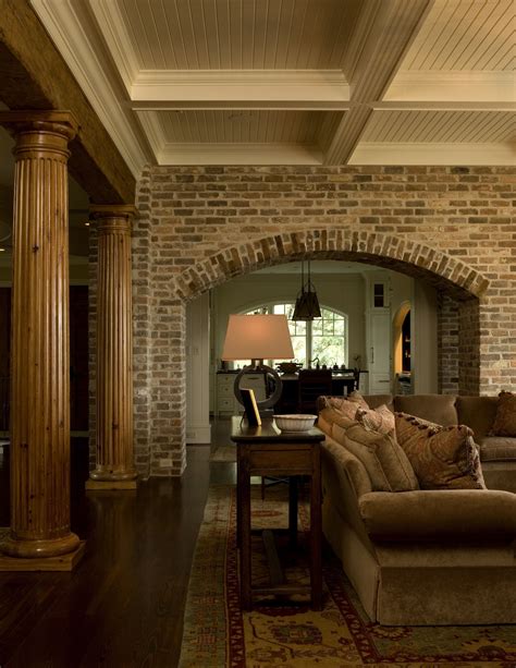 Living Room With Brick Arch Natural Fluted Columns And Painted Wood