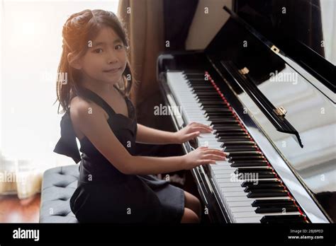Asian Girl Kids Playing Piano Have Talent And Practice For Up Skill Of