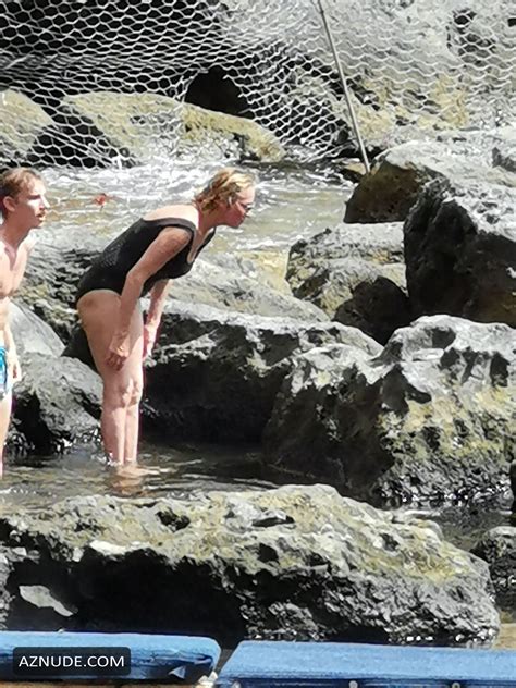 Uma Thurman Sexy Wearing A Black Swimsuit While Checking