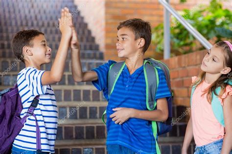 School Kids Giving High Five — Stock Photo © Wavebreakmedia 112899356