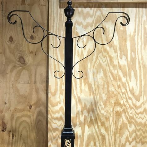 Distressed black with wood tone and anvil iron with driftwood. Victorian Style Wrought Iron Lamp Post Hanging Planter, from Walt Disney World For Sale at 1stdibs